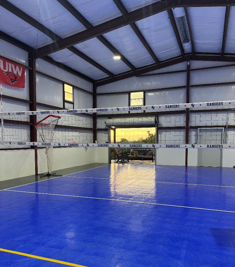 Indoor volleyball court with blue sport surface